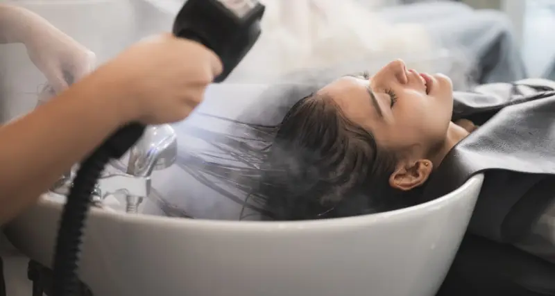 Client having their hair washed at a professional salon