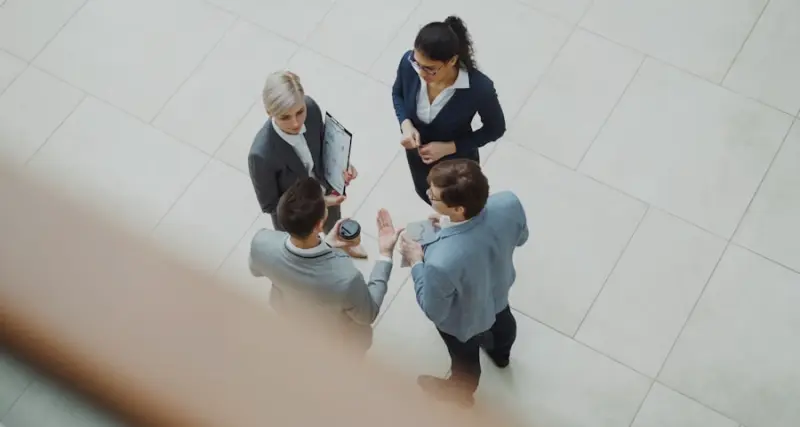 Executives reviewing documents in a corporate boardroom