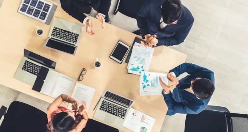 Finance team reviewing figures at a meeting table