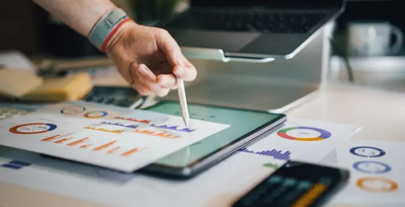 Analyst working through printed data reports